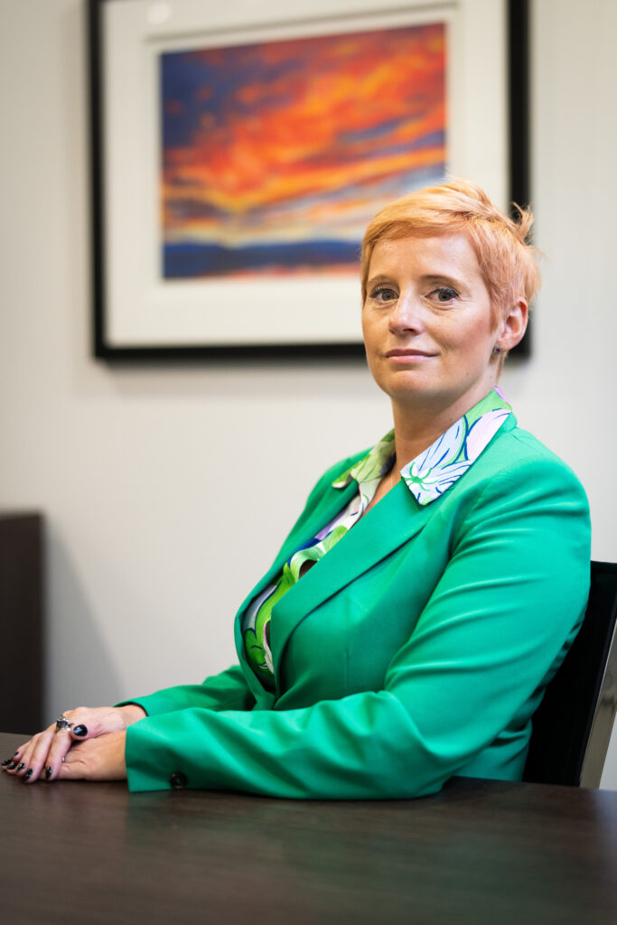 Photograph of Anna Muzyka, personal injury solicitor, sitting at a desk