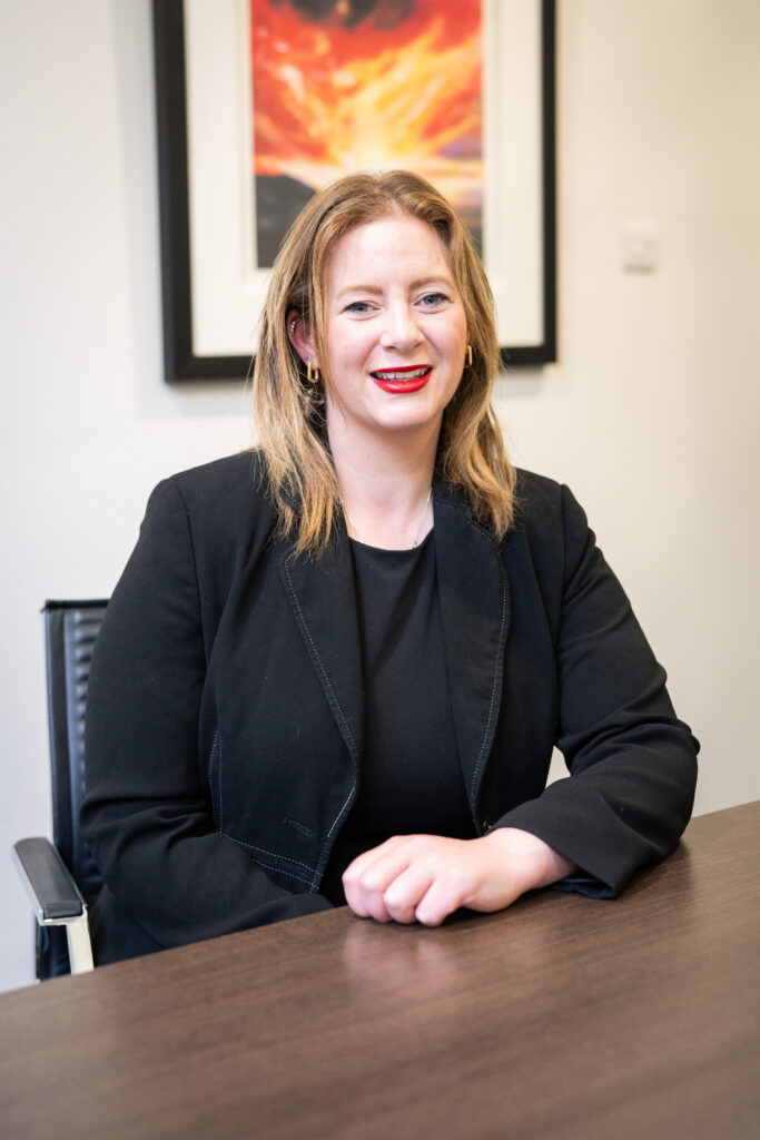 Photograph of Aisling Walsh, Personal Injury Solicitor seated at a desk